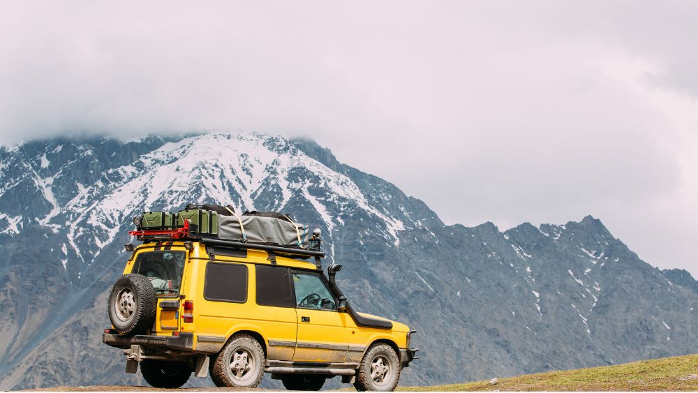 SUV Or Tourist Vehicle Driving Through Bhutan Mountains - Miles with Bhutan
